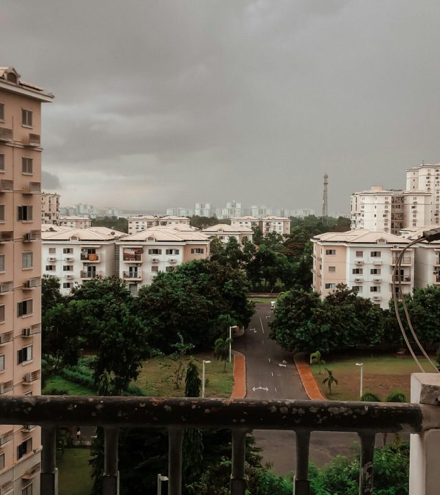 View of a townscape in Angola under an overcast sky, featuring trees and buildings.